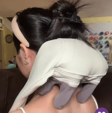 Back view of woman using TheraPexa neck and shoulder massager, showing deep tissue nodes targeting upper back and trap muscles.