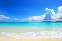 Tropical beach with turquoise water, soft sand, and blue sky with clouds, symbolizing relaxation and stress relief