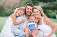 Happy young family smiling outdoors, representing TheraPexa customers prioritizing wellness, self-care, and stress relief at home.